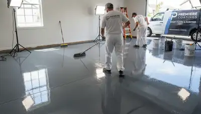 Professional epoxy floor coating application in Charlotte, NC garage by expert painting contractors