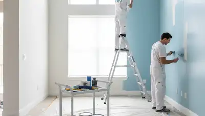 Professional interior house painters working on living room walls in Charlotte, NC